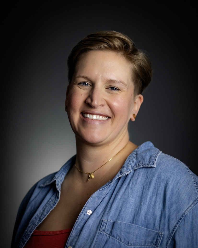 Headshot of Claire Nicholls with black background