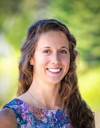 A woman headshot picture with nature background