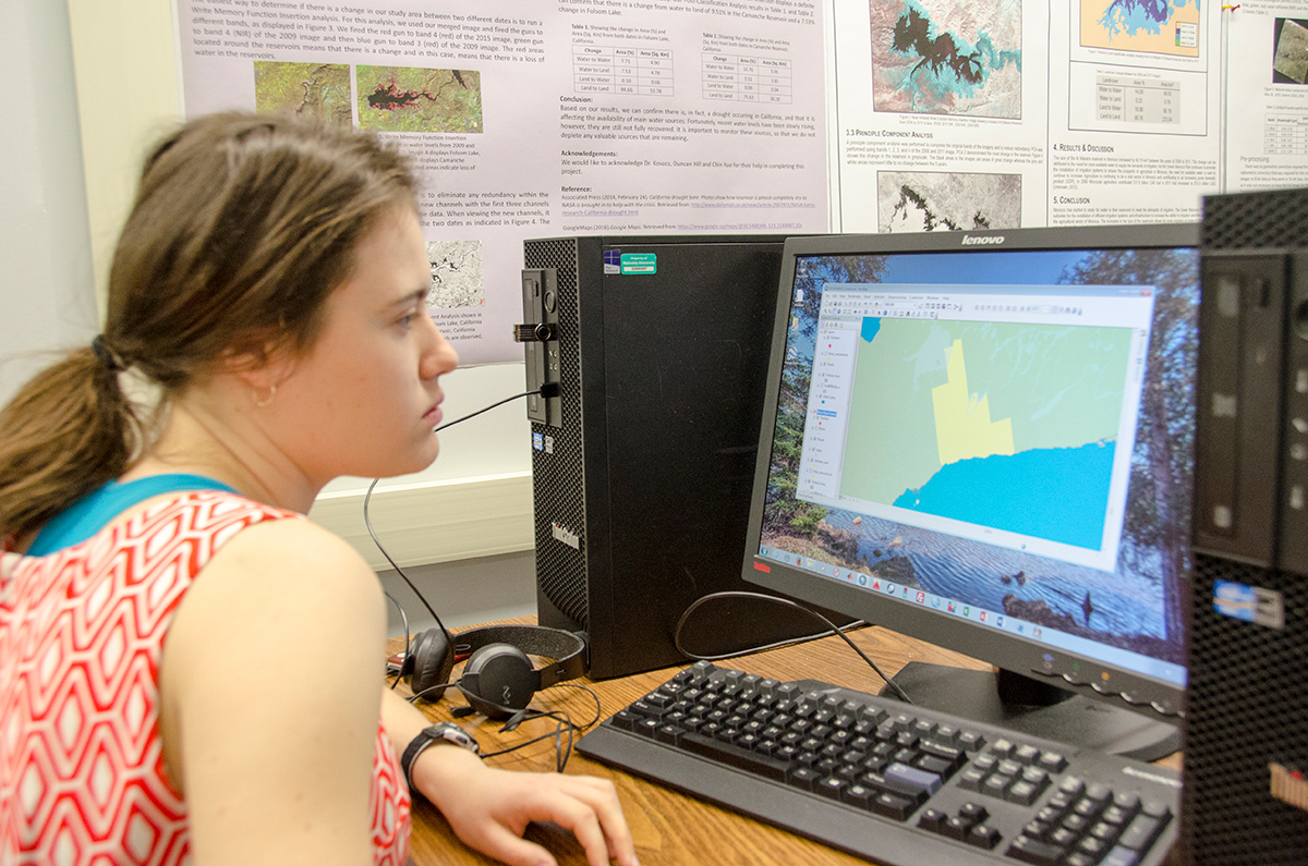 student on a computer in the geomatics lab