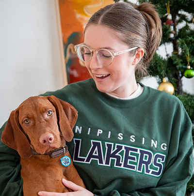 female with Lakers Sweatshirt and dog with Lakers tag