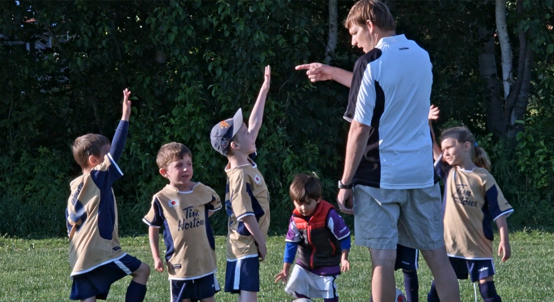 Dr. Mark Bruner coaching youth soccer