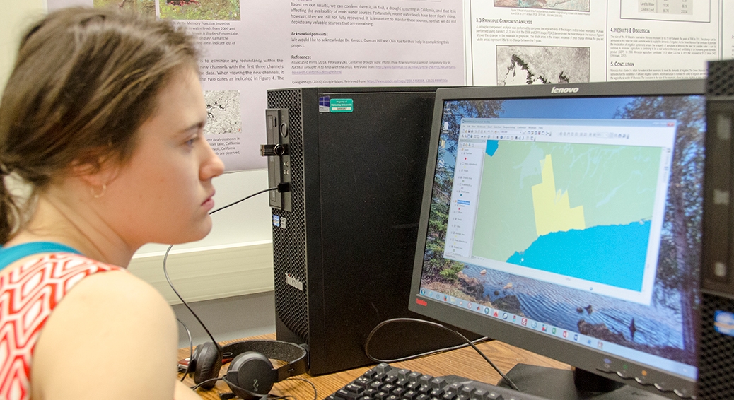student on a computer in the geomatics lab