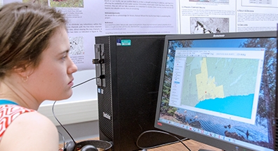 student on a computer in the geomatics lab