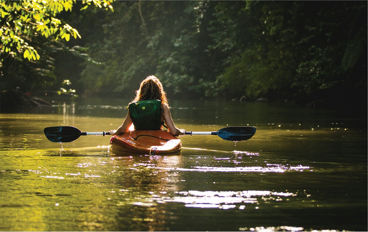 a girl paddling in the La Vase River