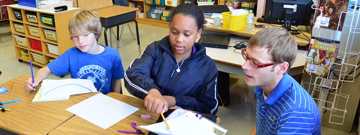 Master of Education candidate with elementary students