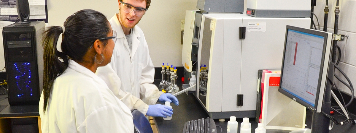 two students in lab coats