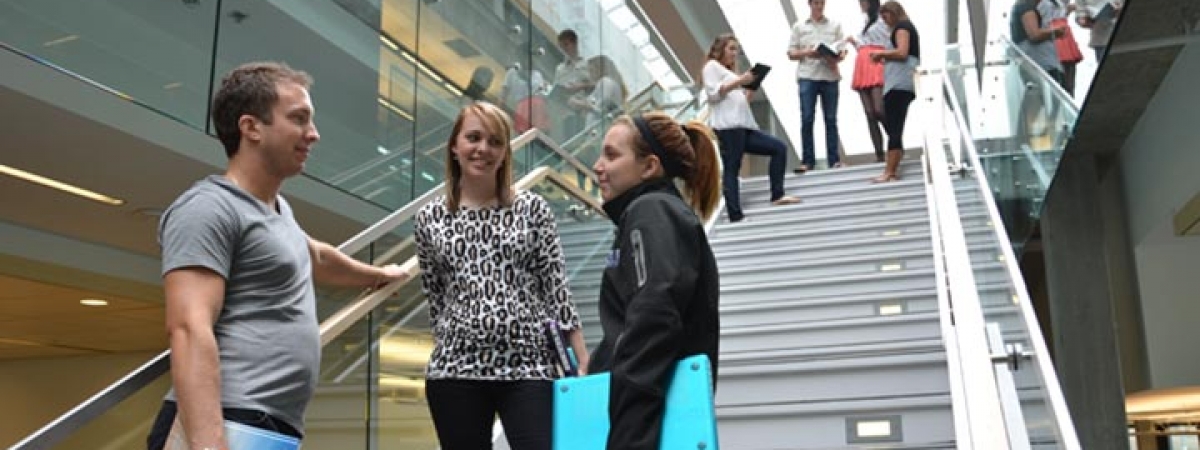 students on stairs in library