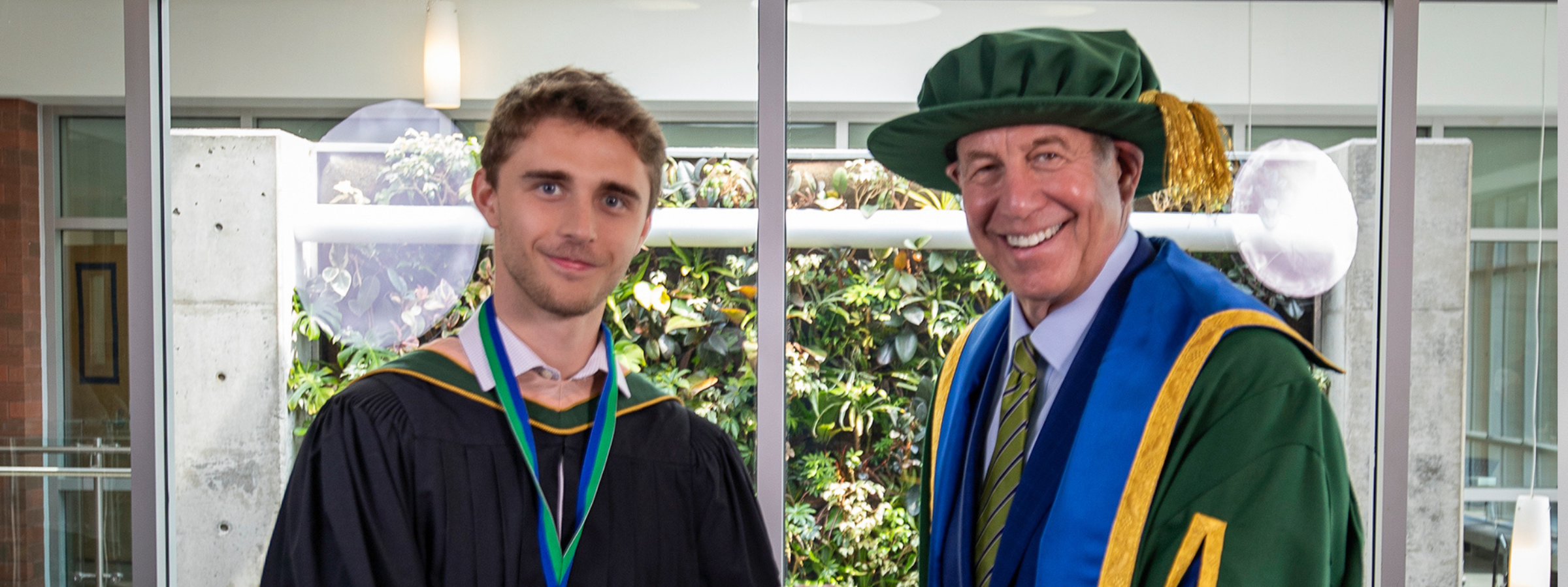 Recipient Hayden Llyod and Chancellor Dr. Russell stand together in convocation regalia.