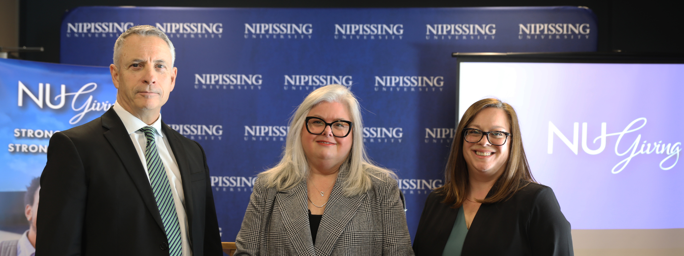 Drs. Wamsley, Sullivan and Law standing in front of a Nipissing background 