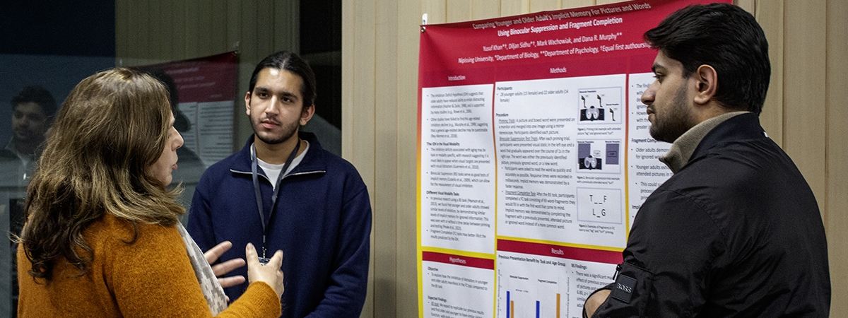 Students and community members networking and showcases research posters