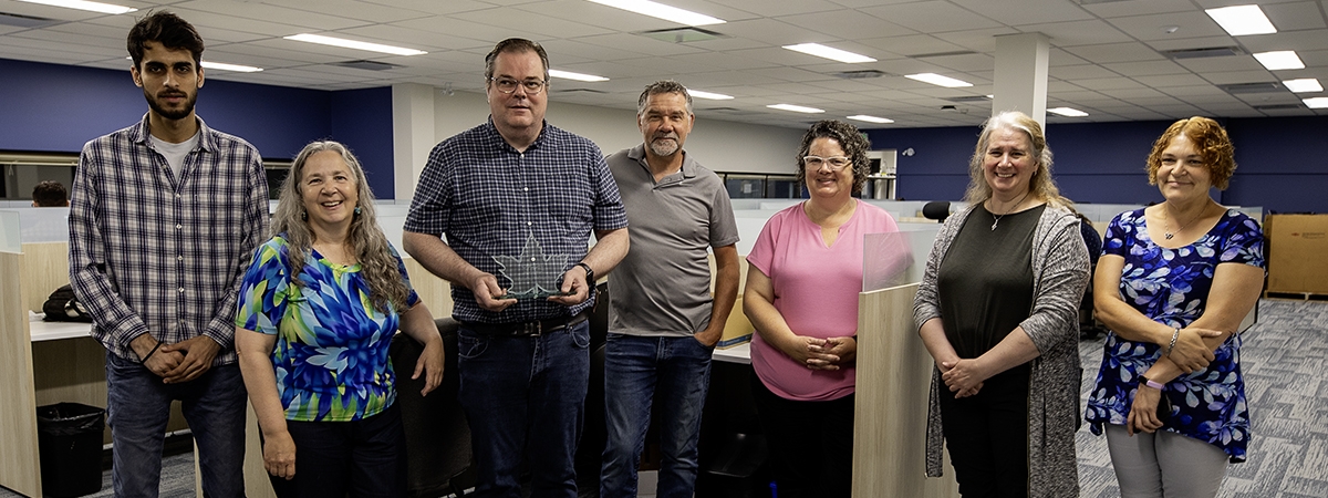 UTS Team Members left to right: Vansh Tyagi, Heather Hersemeyer, Greg Ferguson, Tom Watkins, Shelley Demers, Maria Cooper, Pauline Teal, with Greg holding their award trophy. 