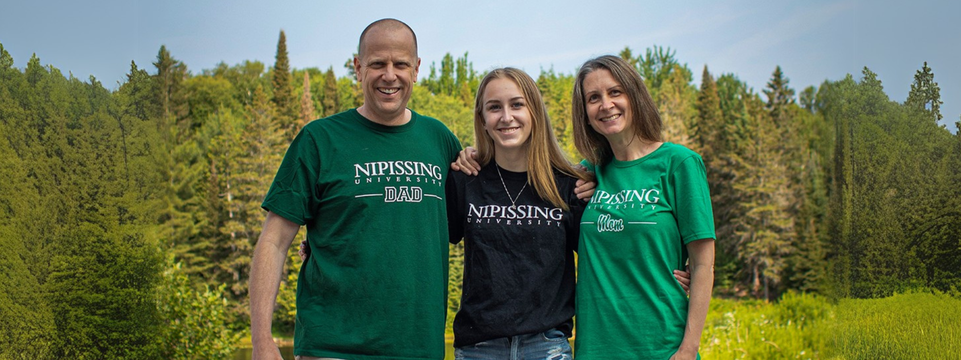 parents and a student posing in front of the pond