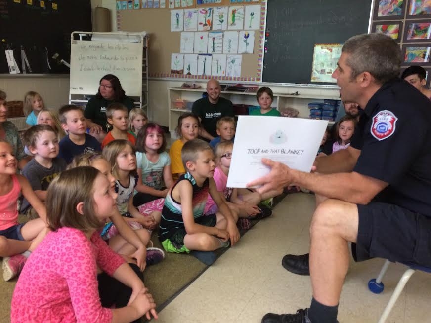 Photo of man teaching children in a classroom