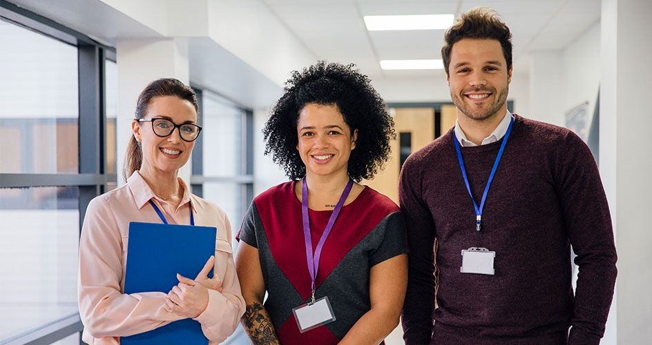 3 teachers standing and smiling for the camera