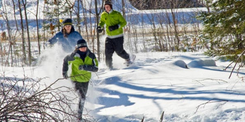 student running in the snow in snowshoes 