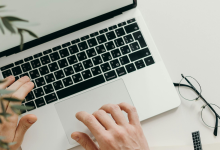 hands typing on a computer