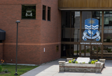 The front entrance of Nipissing University with gardens 