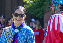 Photo of two pow wow participants donning Indigenous regalia.