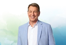 Scott Russell with Nipissing University watercolour branding in the background