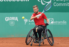 Rob Shaw, wheelchair tennis athlete returns a shot during competition