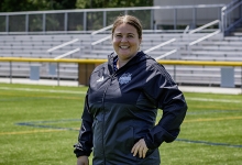 Sarah Batley stands on the Lakers turf field 