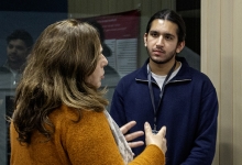 Students and community members networking and showcases research posters