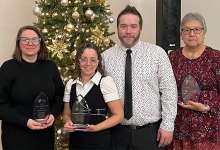 VAWCC Award Recipients stand in front of a holiday tree. 