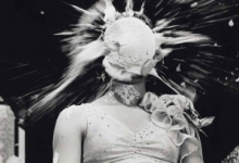 Black and white photo of a woman getting a pie in the face