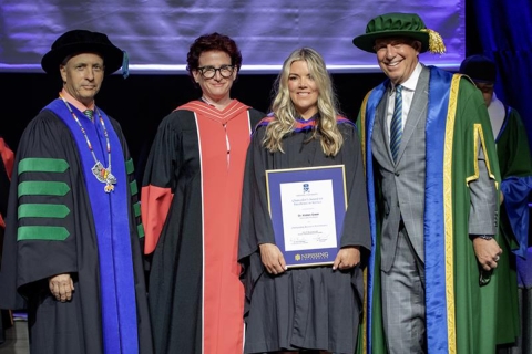 Kirsten Greer receives her award on stage